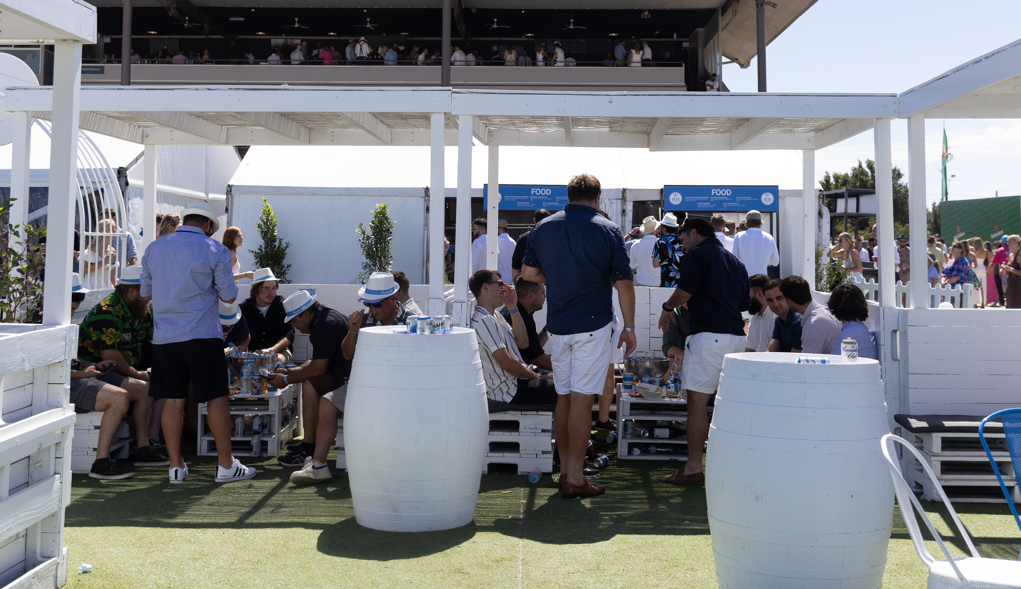 Groups of people enjoying the VIP booth at Caulfield Cup Day